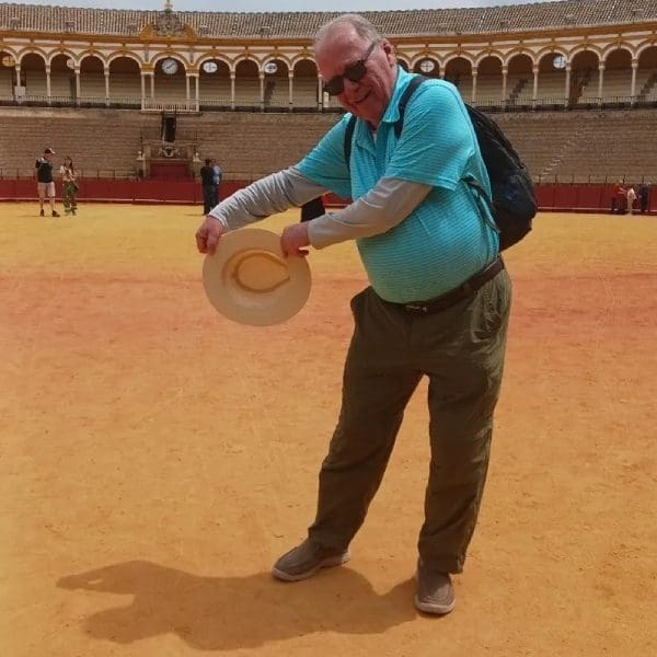 A man in blue shirt holding a frisbee.